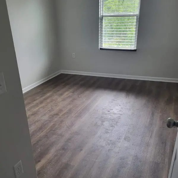 Newly installed wood-look vinyl plank flooring in an empty room
